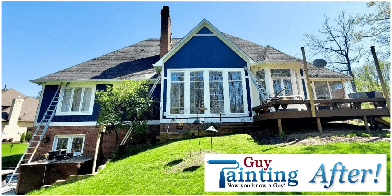 A beautiful residential brick exterior with dark trim accents and a fresh, clean paint application, completed by an expert house painting professional.