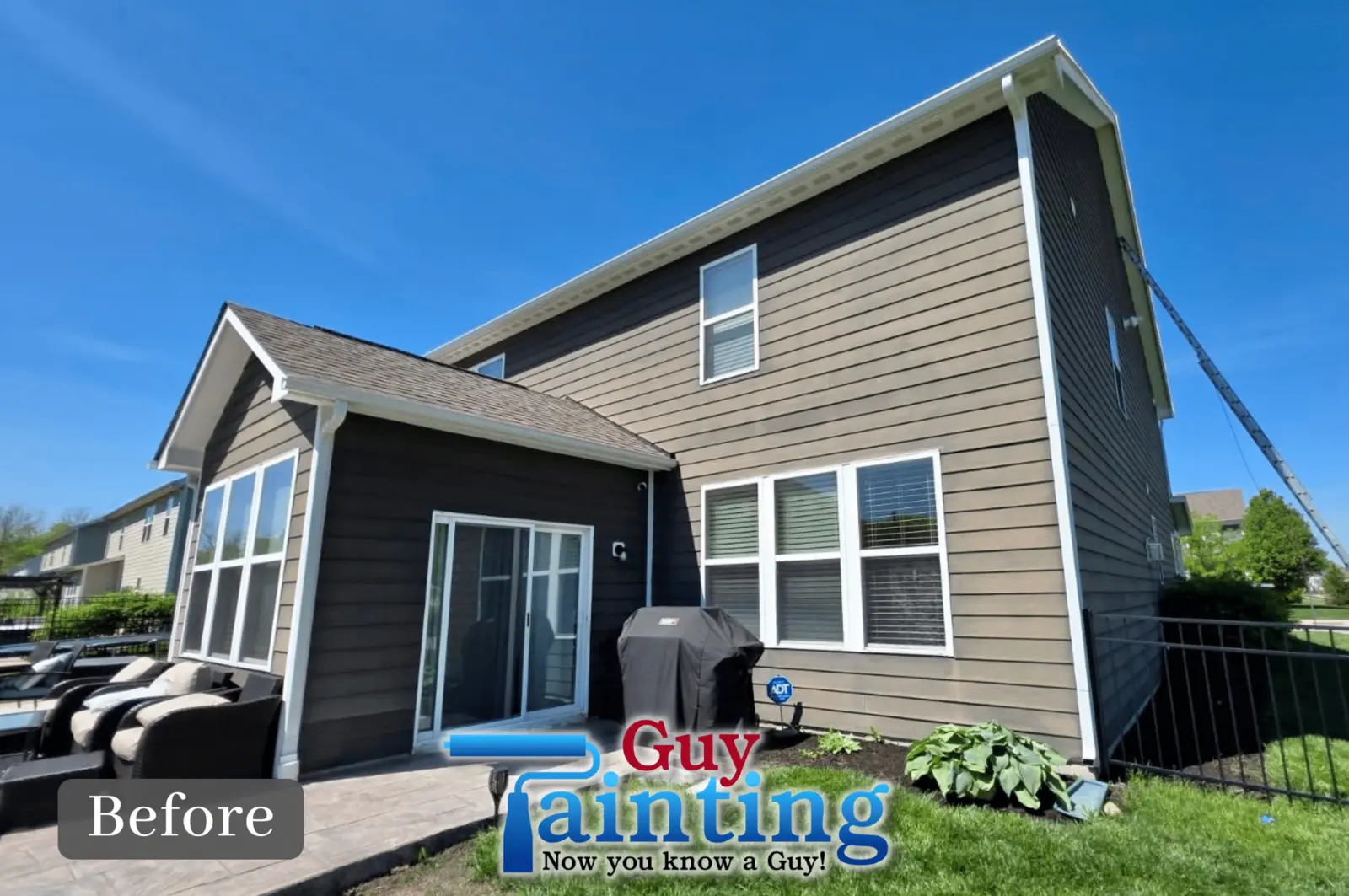 Back of a Noblesville, IN home with faded, chalky builder-grade siding paint, before repainting